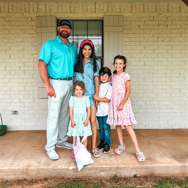 Group Picture of the Hass Family wearing tones of pink and blue.